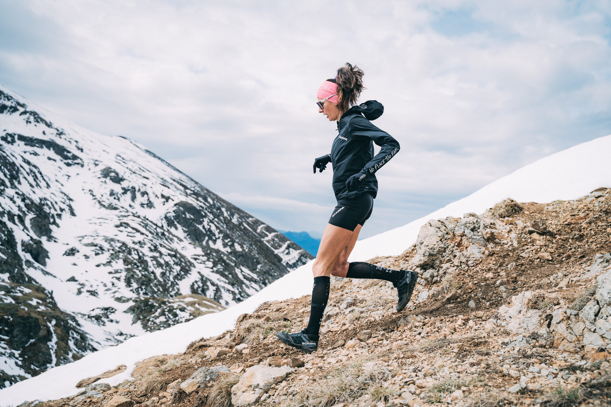 woman runs down a mountain